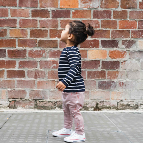 Child wearing merino baby long sleeve top navy Breton stripes
