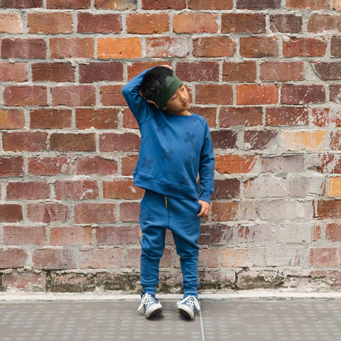 Boy wearing organic cotton merino trackie pants denim blue
