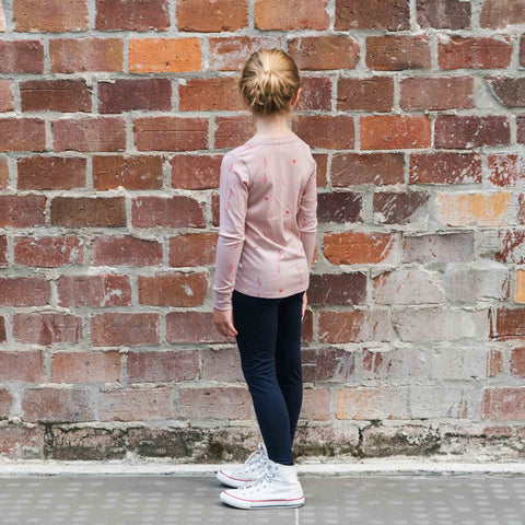 girl wearing legging and merino long sleeve top blush pink with print