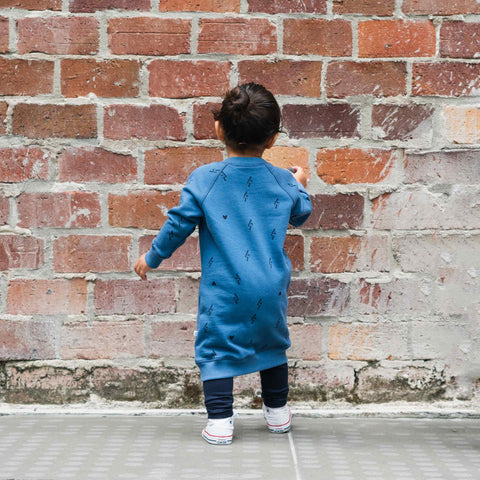 Child wearing organic cotton merino baby trackie dress denim blue lightning heart