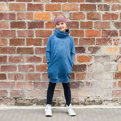 Girl wearing organic cotton merino trackie dress denim blue lightning heart