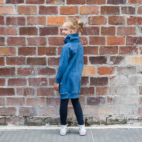 Child wearing organic cotton merino trackie dress denim blue lightning heart