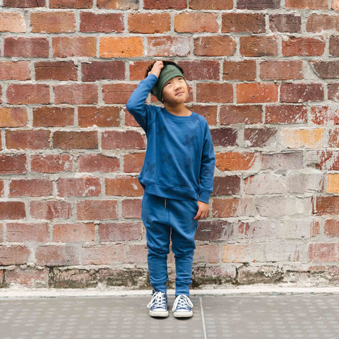 boy wearing cotton merino headband olive and trackies