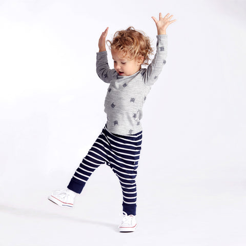 Child wearing slouch pants and merino baby long sleeve top grey marl batboy print