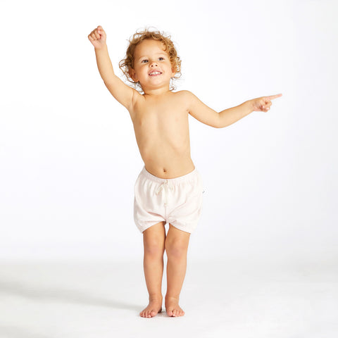 girl wearing merino bloomers in soft pink