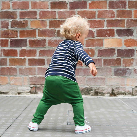 Child wearing merino baby slouch pants moss green