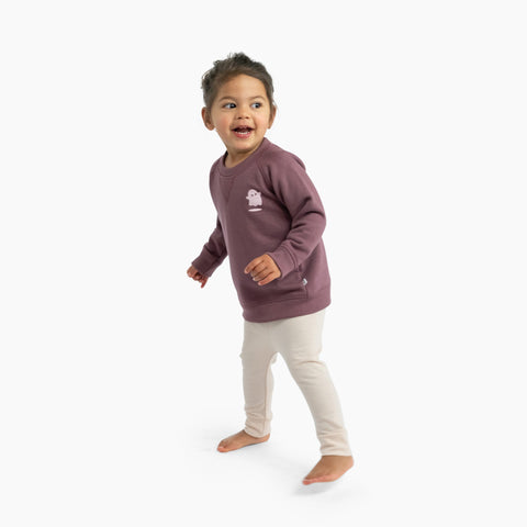 Toddler wearing leggings and cotton merino sweater plum