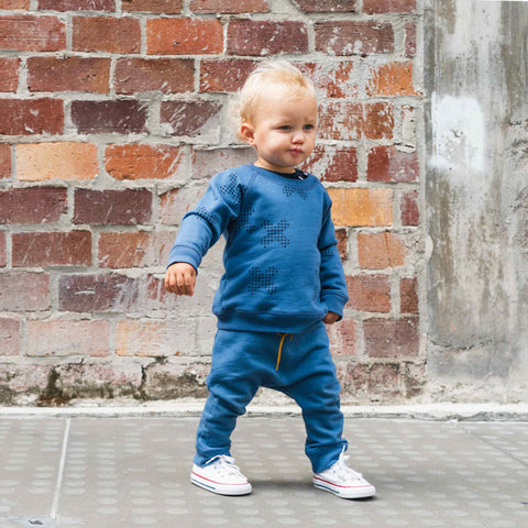 Boy wearing organic cotton merino baby slouch trackie denim blue