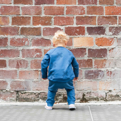 Child wearing organic cotton merino baby slouch trackie denim blue