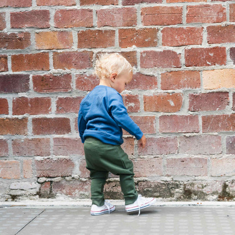 Boy wearing organic cotton merino baby slouch trackie olive green