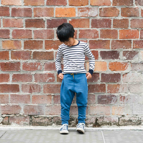 Child wearing organic cotton merino trackie pants denim blue