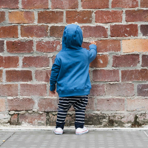 Child wearing hood of cotton merino hoodie denim blue
