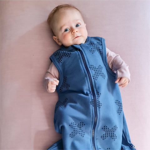 Child wearing organic cotton merino sleep sack denim blue