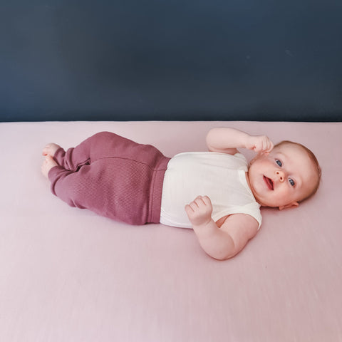 Baby wearing singlet and organic rib cotton leggings plum